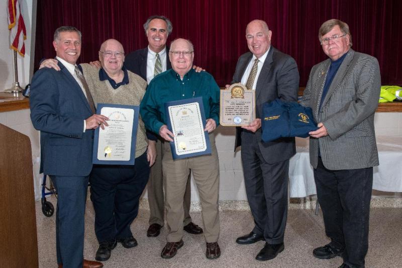 William McManus, a 50-year RBVFC member, receives tributes presented by Rep. Pete Schwartzkopf, D-Rehoboth Beach; Rep. Steve Smyk, R-Milton; and Sen. Ernie Lopez, R-Lewes. Shown are (l-r) Smyk, RBVFC President Danny Mitchell, Lopez, McManus, Schwartzkopf and RBVFC Chief Chuck Snyder. SUBMITTED PHOTOS